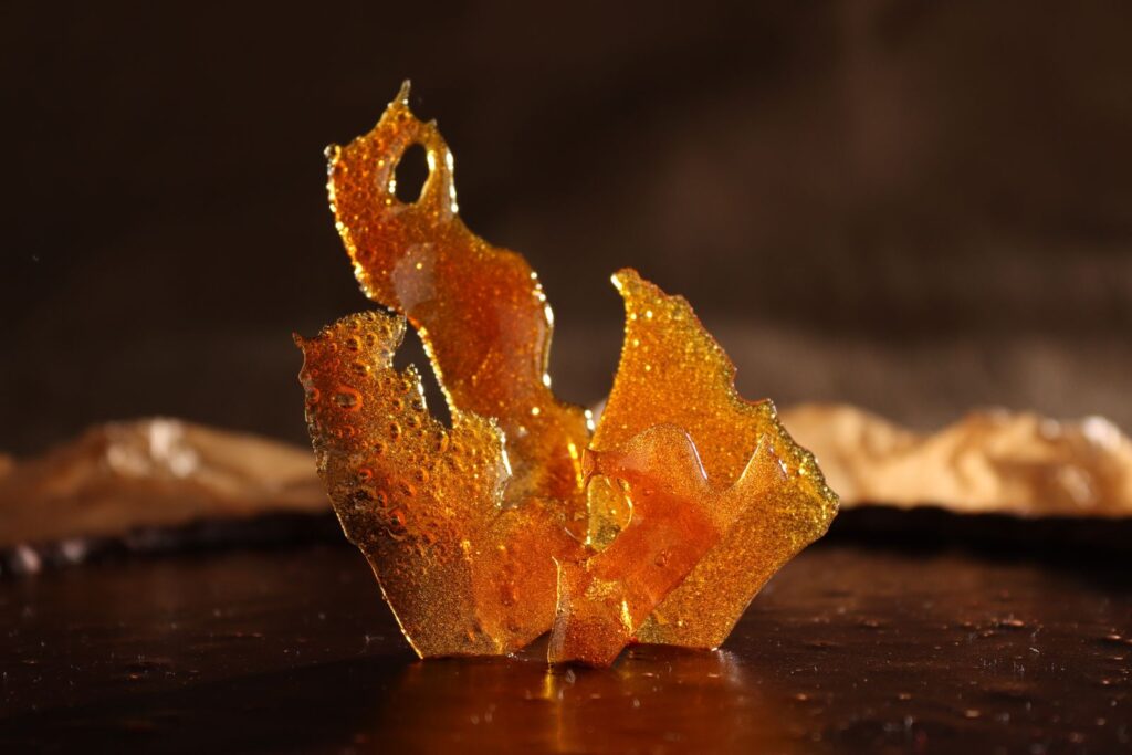 Shard of amber hardened caramel with glossy bubbles, illustrating caramel color and the question of whether it is gluten free