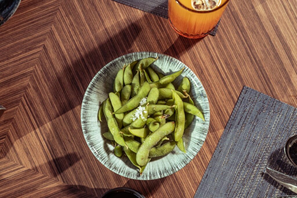Bowl of steamed edamame soybeans sprinkled with salt, a whole-food look at soy, the source of soy lecithin